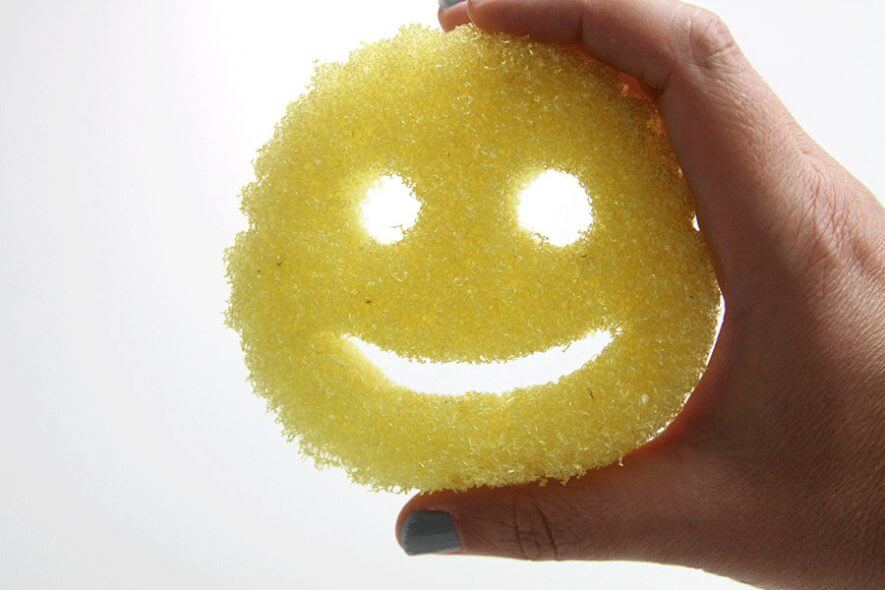 Person's hand holding Scrub Daddy sponge